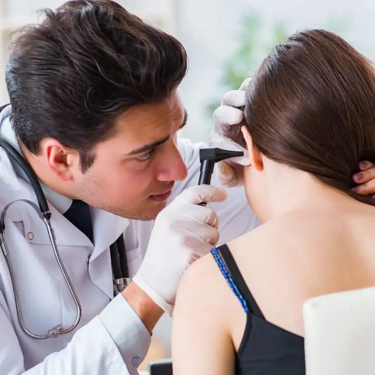 Doctor examining a patient's ear